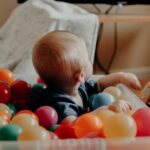 independent occupational therapist with baby in ball pit